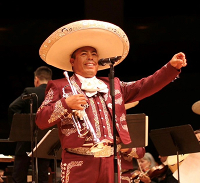 Juventino Romero performing with trumpet onstage