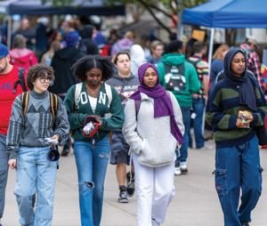 Students walking on campus during a fair