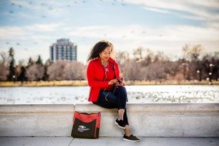 MSU Denver online student studying near the waterfront