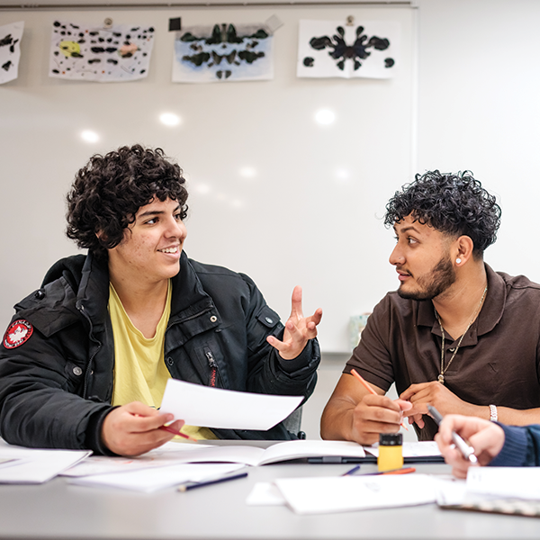 Two students talking during class