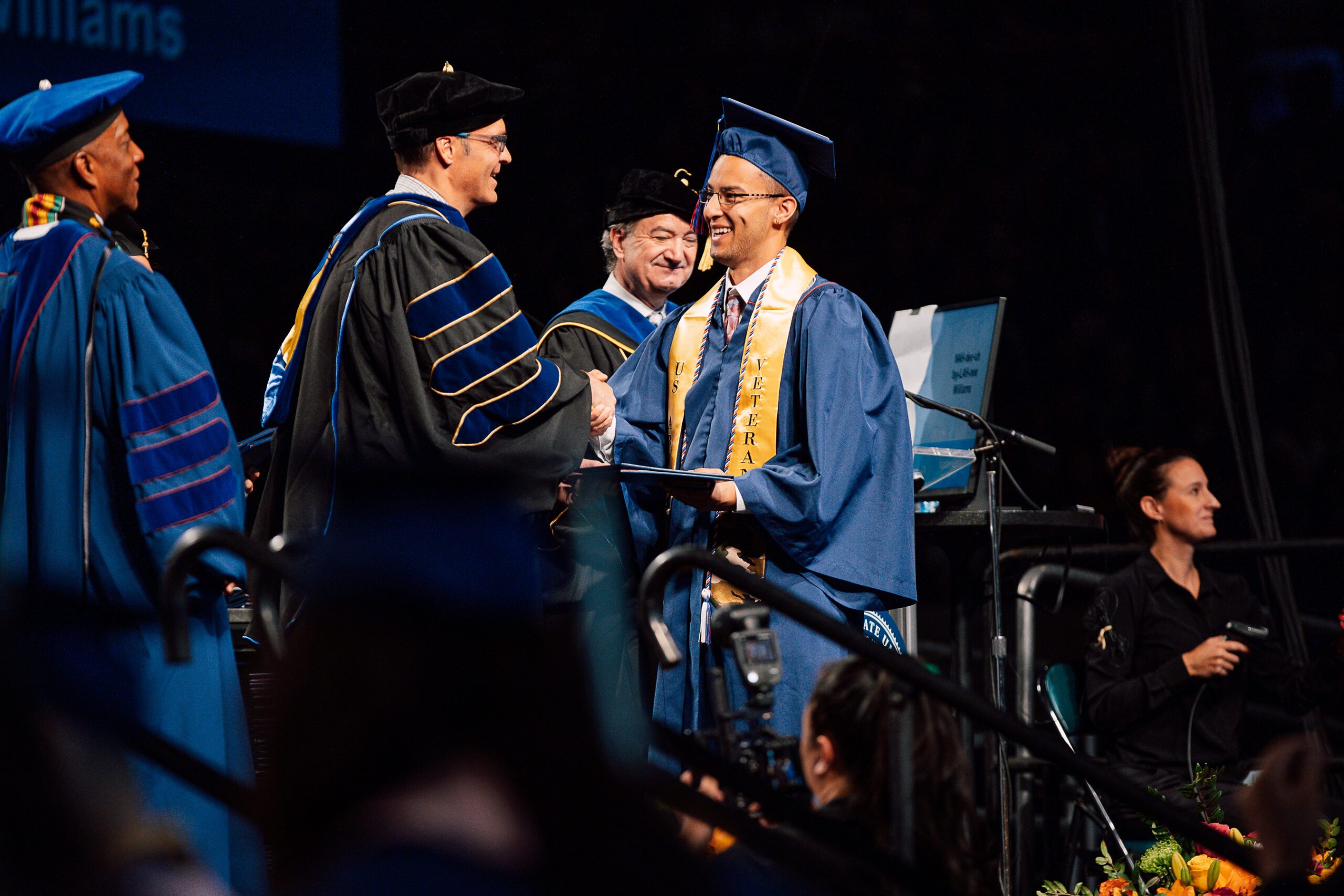 Photo of Political Science Student receiving his diploma.