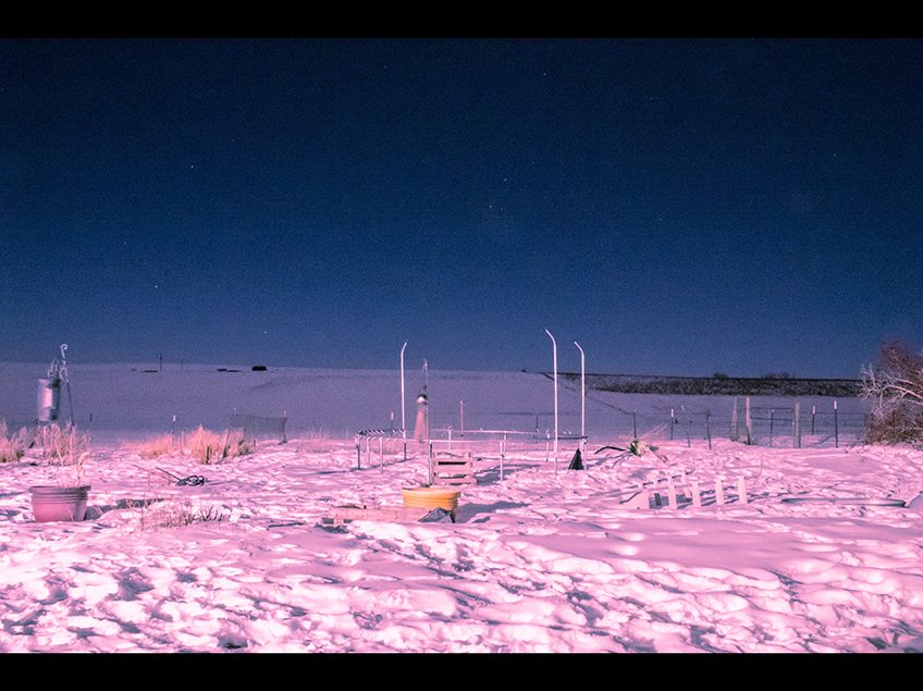 Color night landscape with a horizon. Snow in the foreground tinted pink.