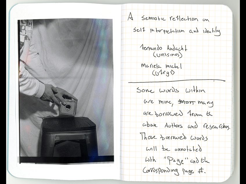 Black and white image of hands placing object on a stool with handwritten notes.