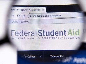 Magnifying glass zooming in on the Federal Student Aid website
