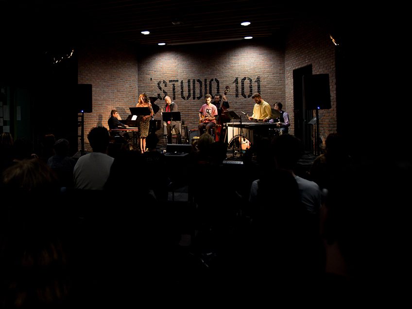 a jazz band performing before an audience in studio 101