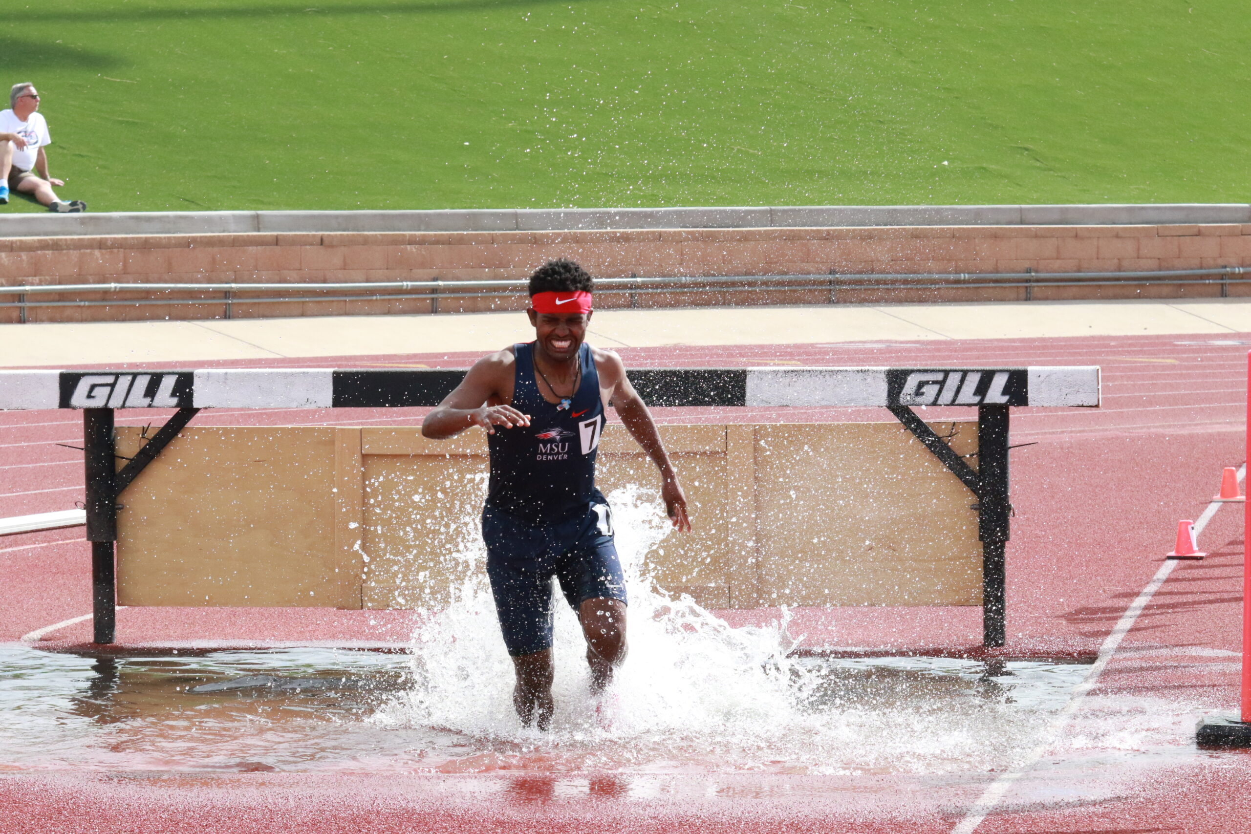 Yoni Kefle landing in the water pit during a steeplechase race