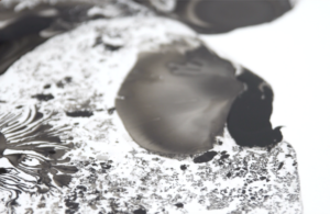 Abstract black and white textured composition with bold shapes and intricate patterns.