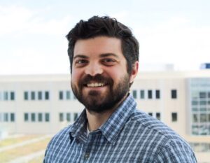 Man smiling in blue shirt