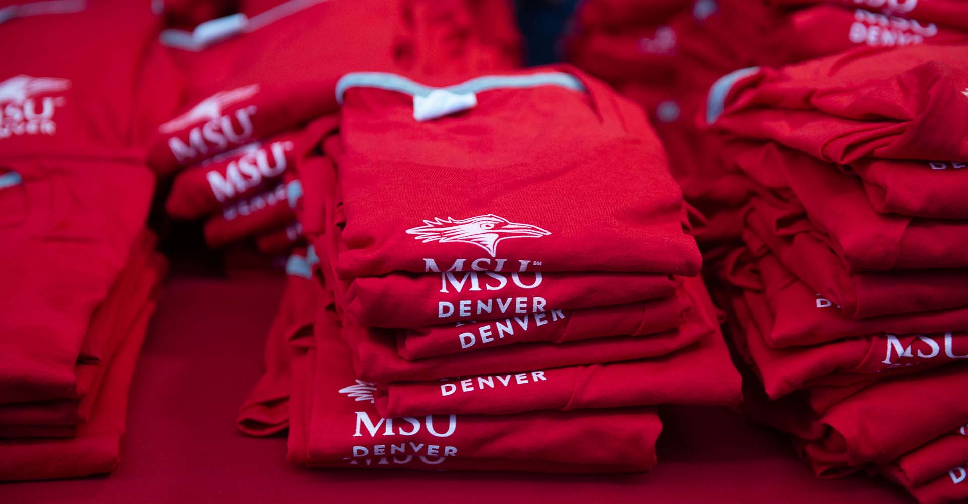 Stack of red MSU Denver t shirts