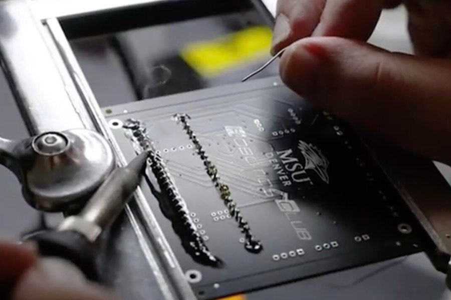 Hand soldering a PCB board