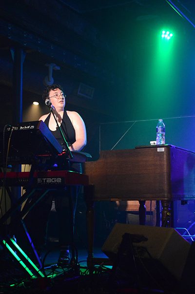 Addy Himle playing keyboard onstage