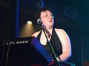 Addy Himle playing keyboard onstage