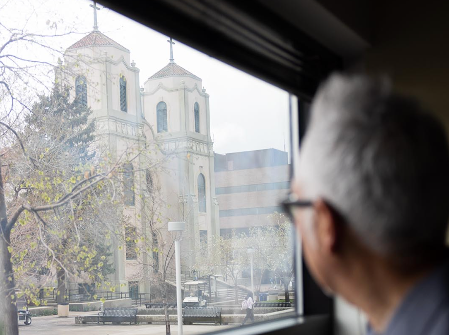 MSU Denver art professor and alum Carlos Fresquez looks at St. Cajetan's out of his office window.