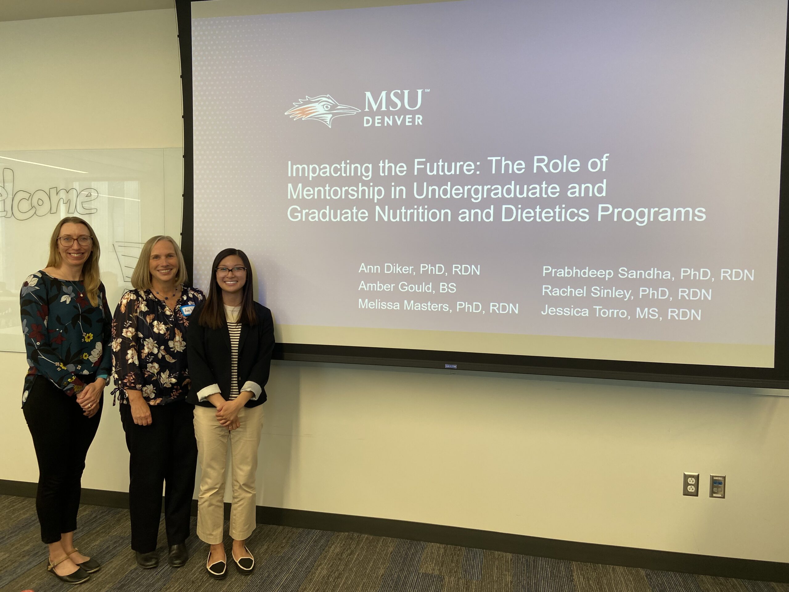 A photo of faculty members giving a presentation on the role of mentorship in Nutrition and Dietetics Programs.