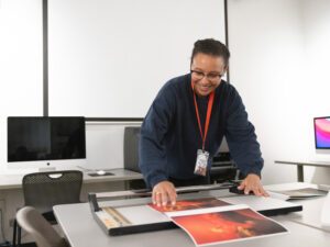 A student crops a print in the Photography Lab.