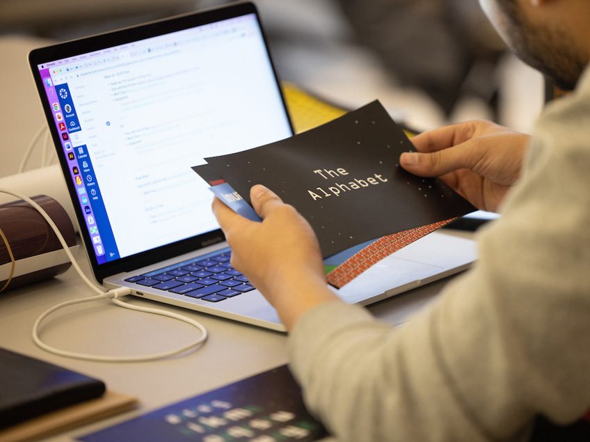 A student prepares print materials.