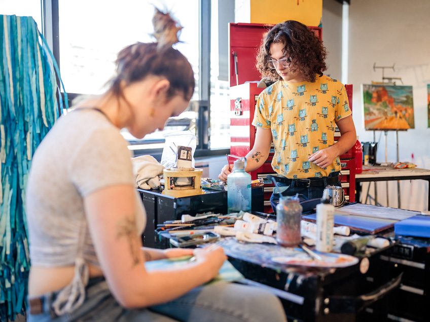 MSU Denver students, Joshua Capentor, right, and Sadie Hughes, works on a project in Painting and New Contexts class on May 3, 2023. Photo by Alyson McClaran