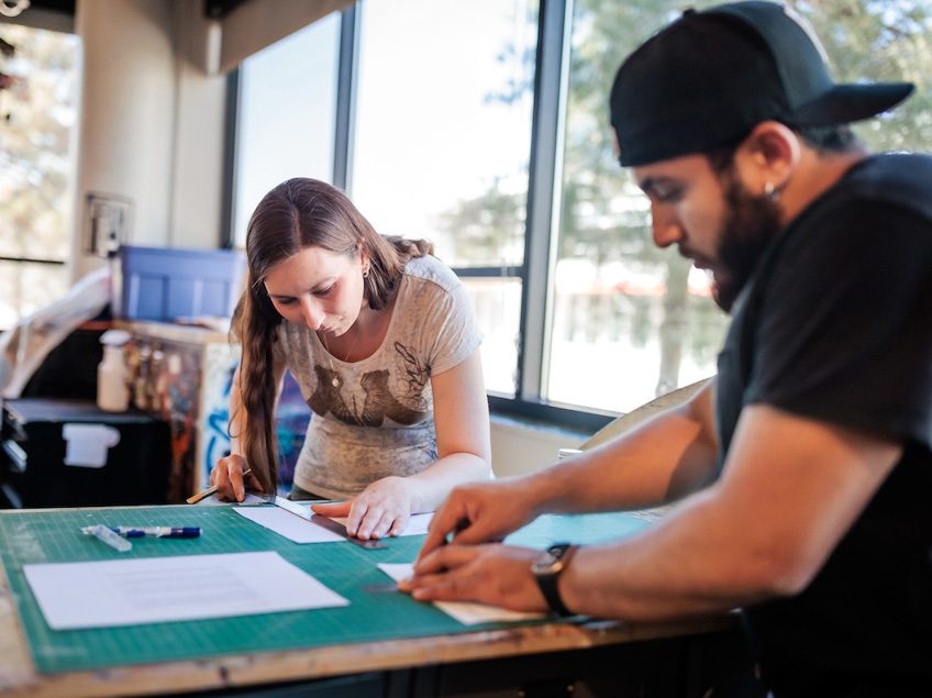 MSU Denver student Jamie McCurdy cuts paper in Painting and New Contexts class on May 3, 2023. Photo by Alyson McClaran