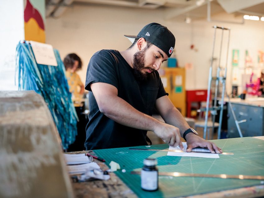 MSU Denver student Alexis Vasquez cuts paper in Painting and New Contexts class on May 3, 2023. Photo by Alyson McClaran