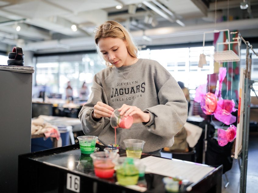 MSU Denver student, Avery Jacobson pours paint in Painting and New Contexts class on May 3, 2023. Photo by Alyson McClaran