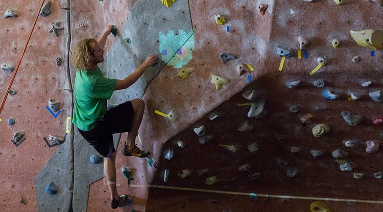 Student climbs a climbing wall on Auraria Campus