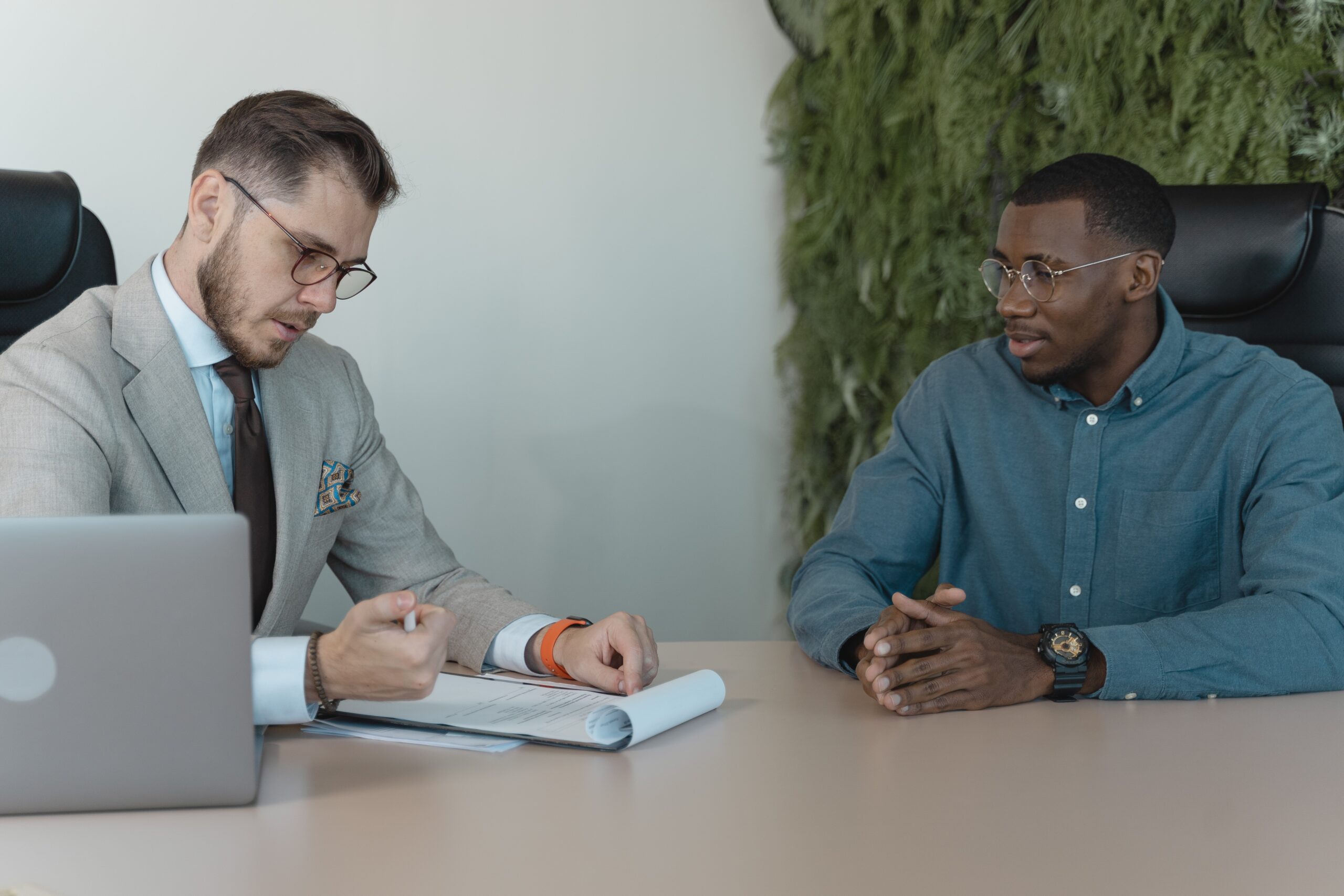 Two individuals discussing work things