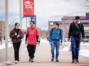 A group of students walking through a snowy Auraria Campus.