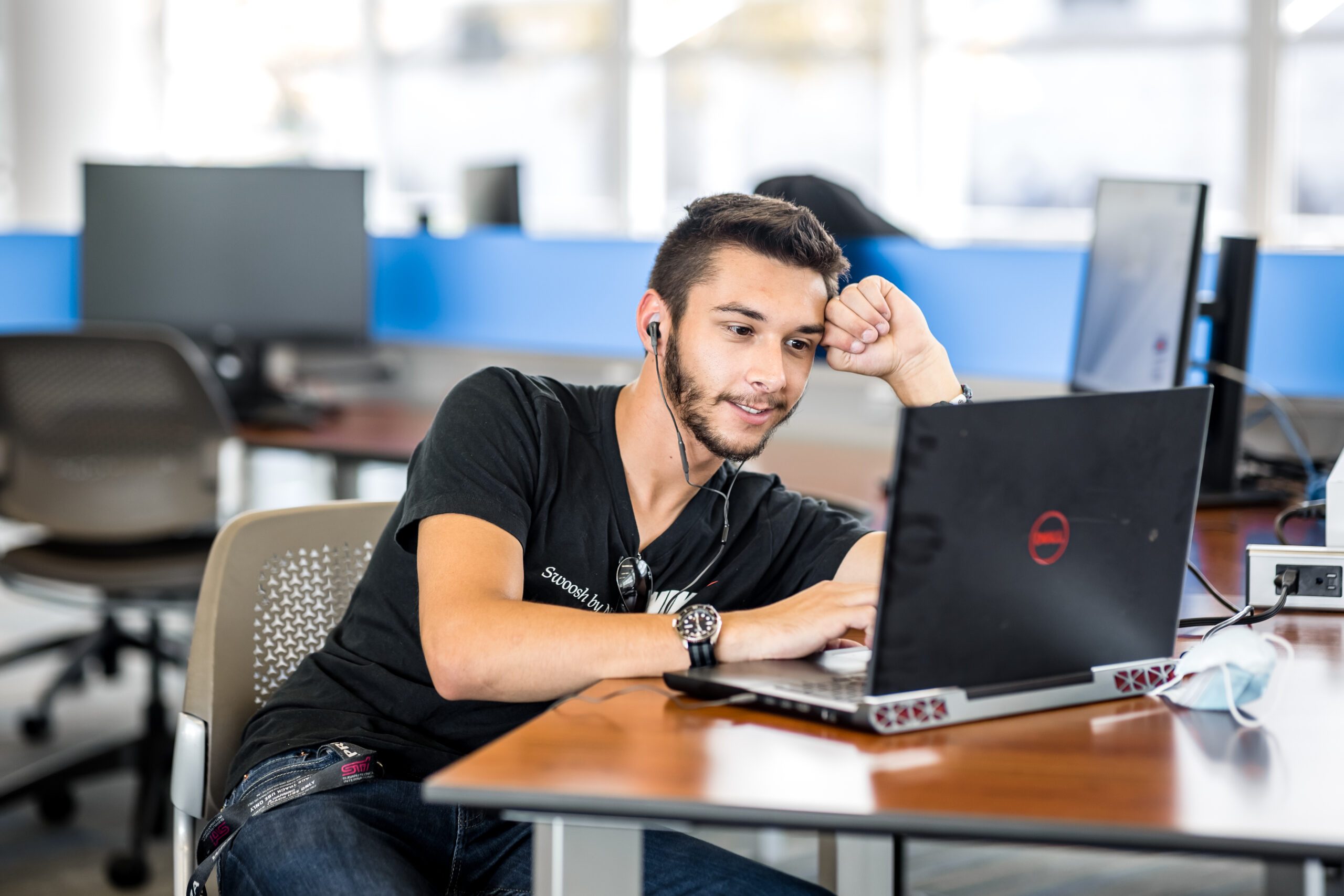 Student working at a desk on a laptop