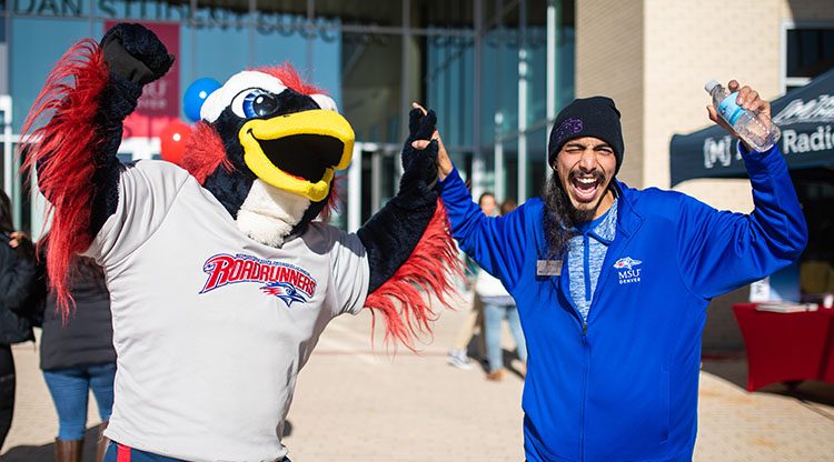 Rowdy and an MSU Denver tour guide embrace at Open House
