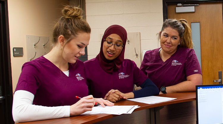 Nursing students reviewing coursework.