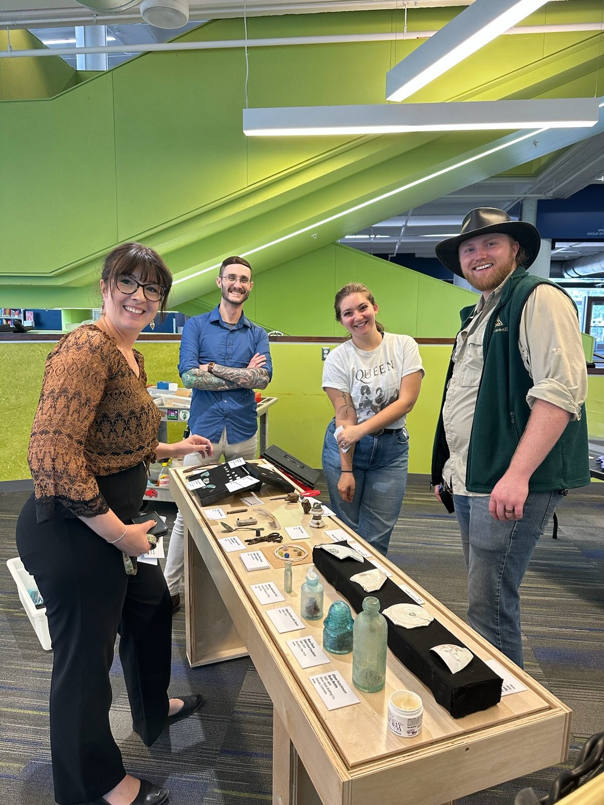 Anthropology faculty and students setting up Auraria archaeology display in the Auraria Library.