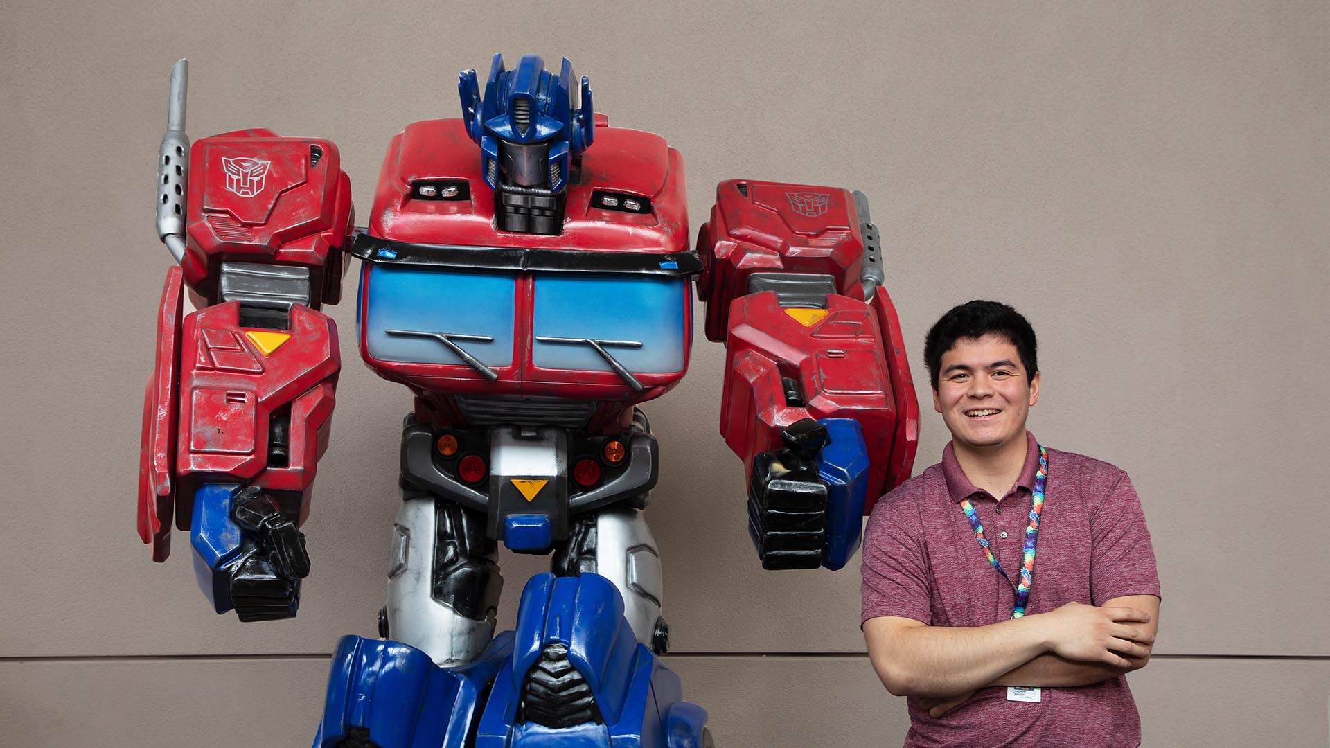 Andrew Baxter posing with a transformer like figure.