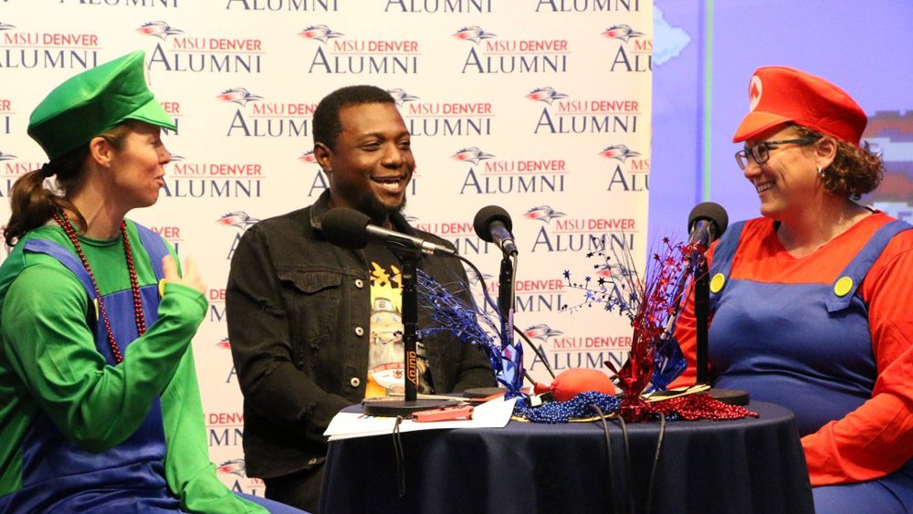 Brandi Rideout and Jamie Hurst dressed in Mario and Luigi costumes, talking with Damarley Laing during the 2023 Day of Giving telethon