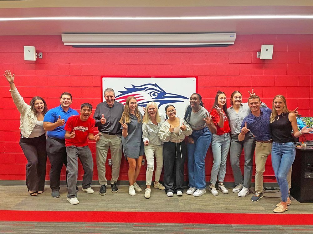 Recipients of the Cohen Pacesetter Scholarship smiling and laughing with Rob and Molly Cohen at The Assembly Athletic Complex