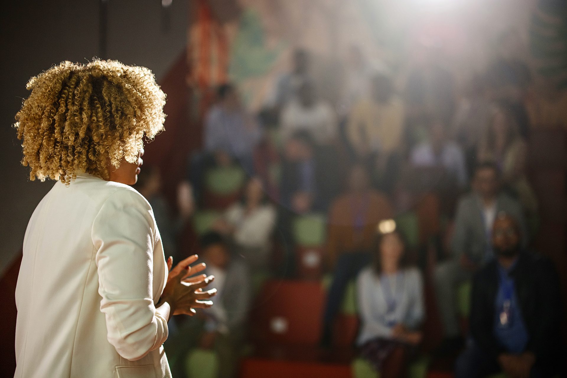 Woman giving a speech in an auditorium