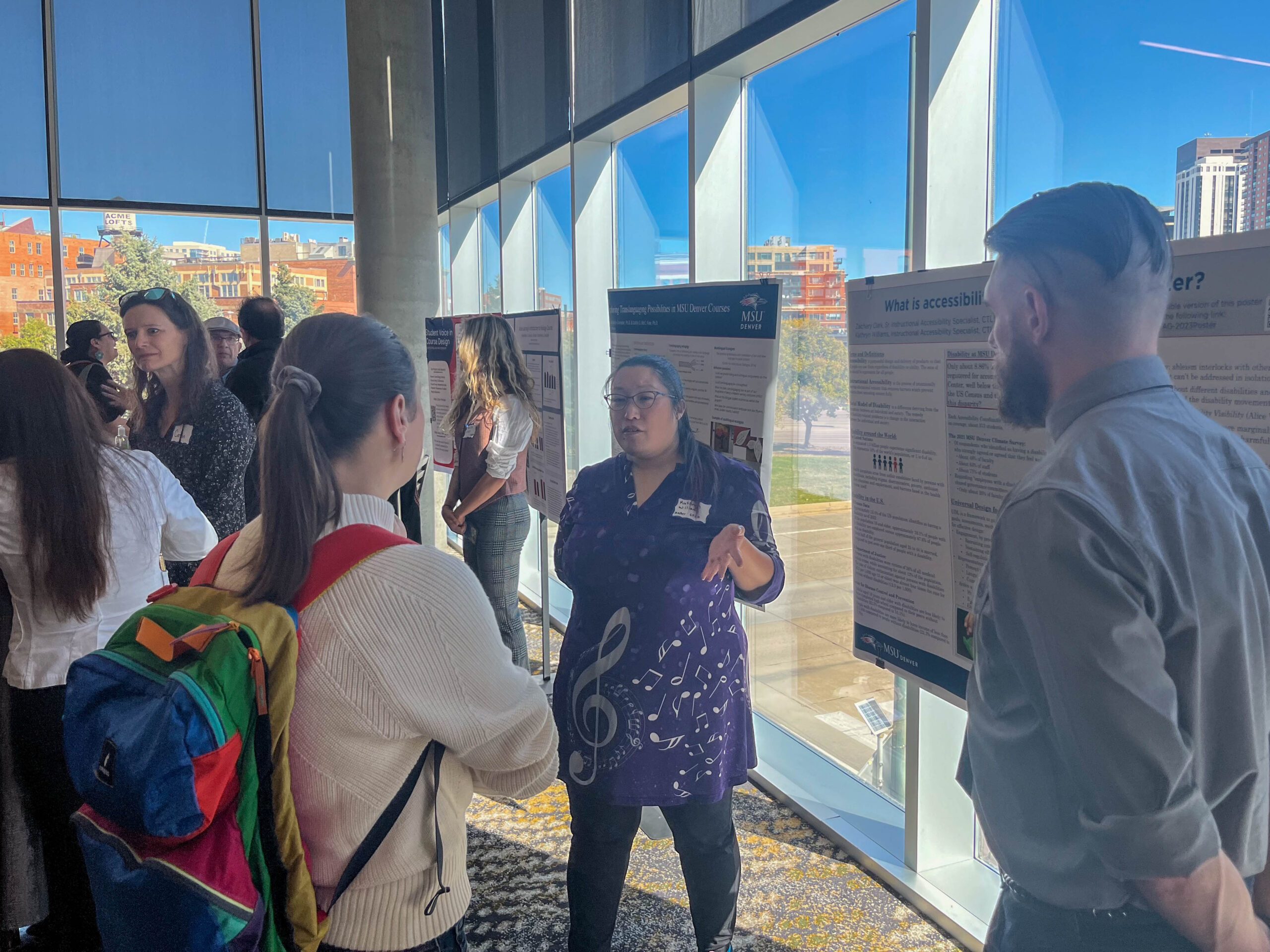 Faculty and staff discussing research projects at the SoTL poster session