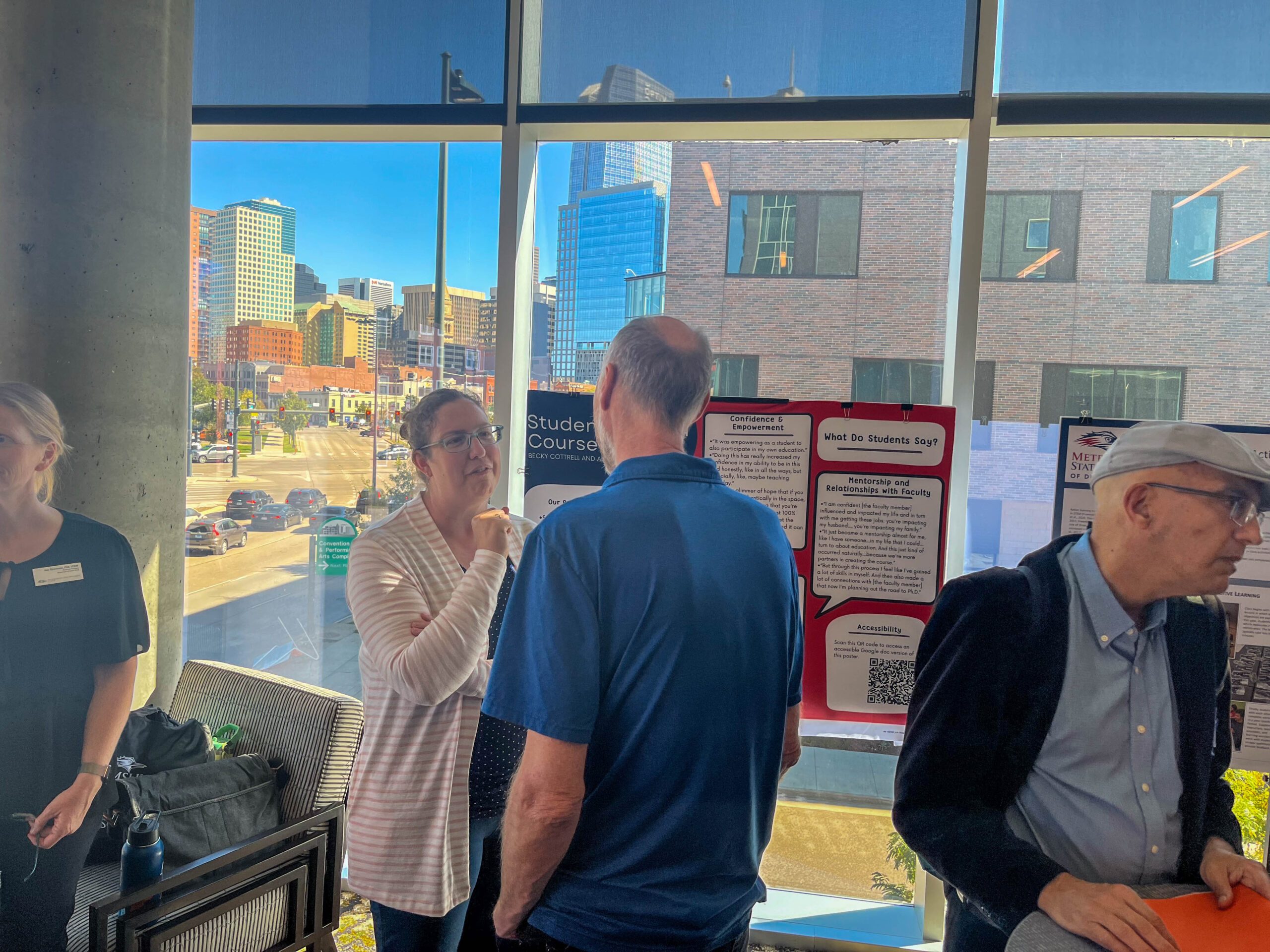 Faculty and staff discussing research projects at the SoTL poster session