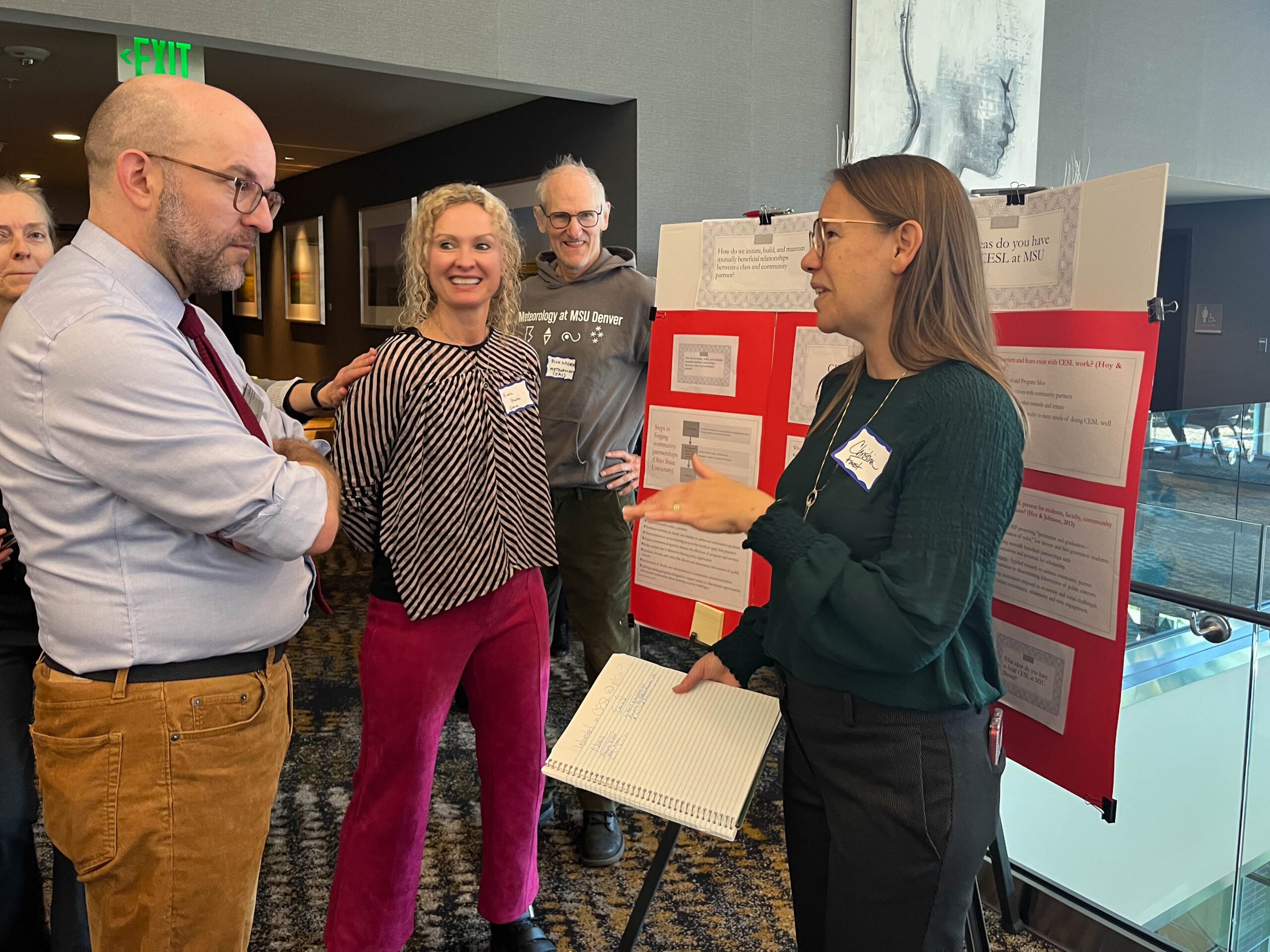 Faculty and staff discussing research projects at the SoTL poster session