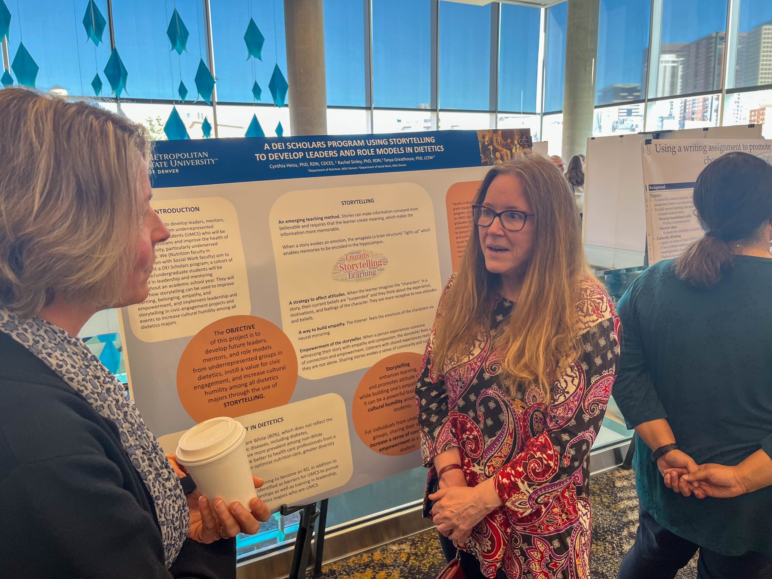 Faculty and staff discussing research projects at the SoTL poster session