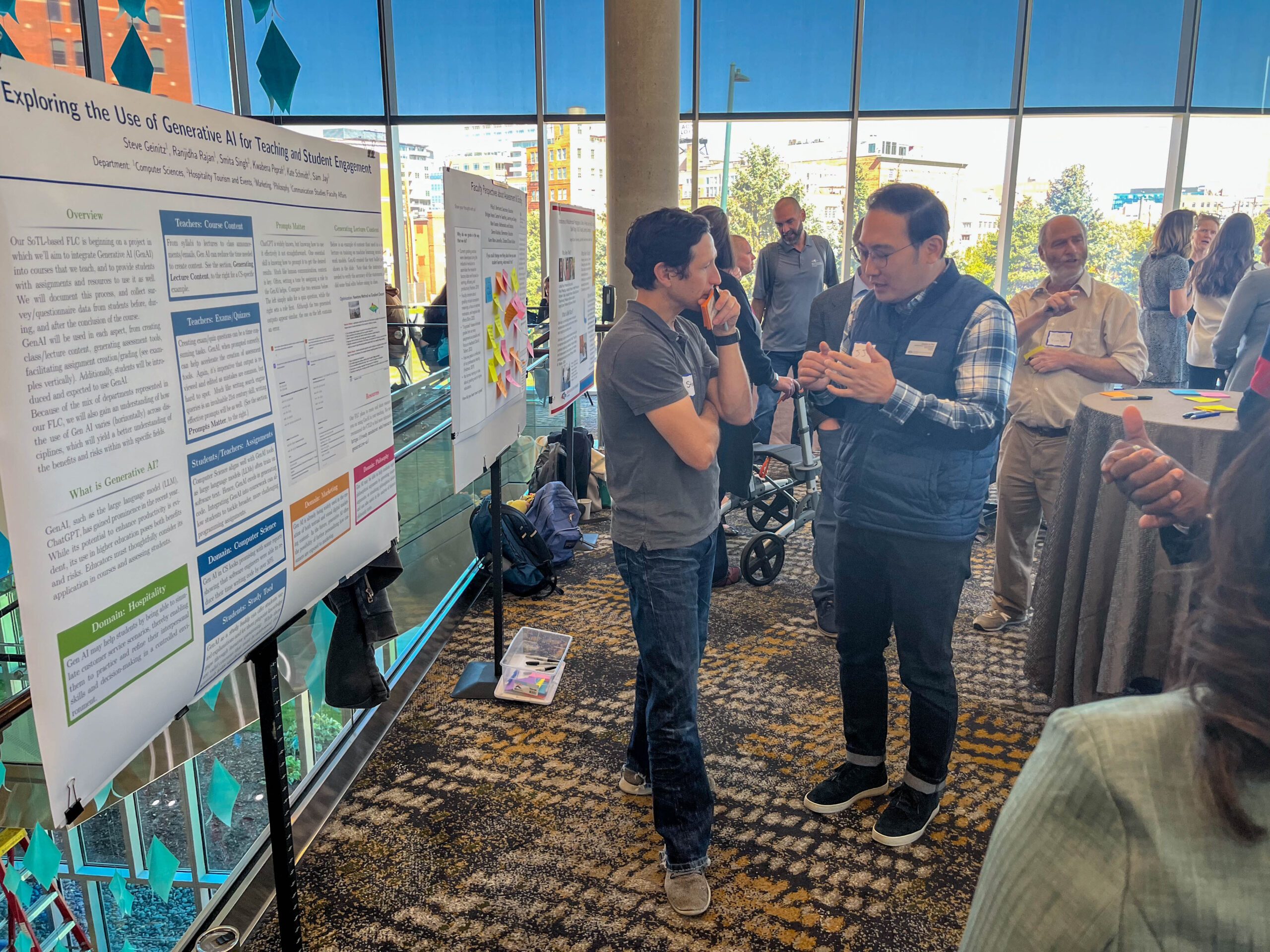 Faculty and staff discussing research projects at the SoTL poster session