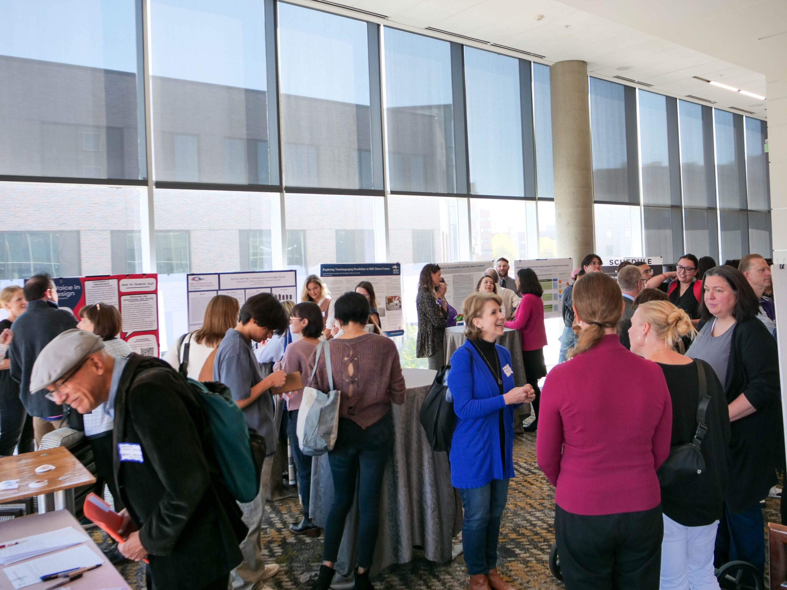 Faculty and staff discussing research projects at the SoTL poster session