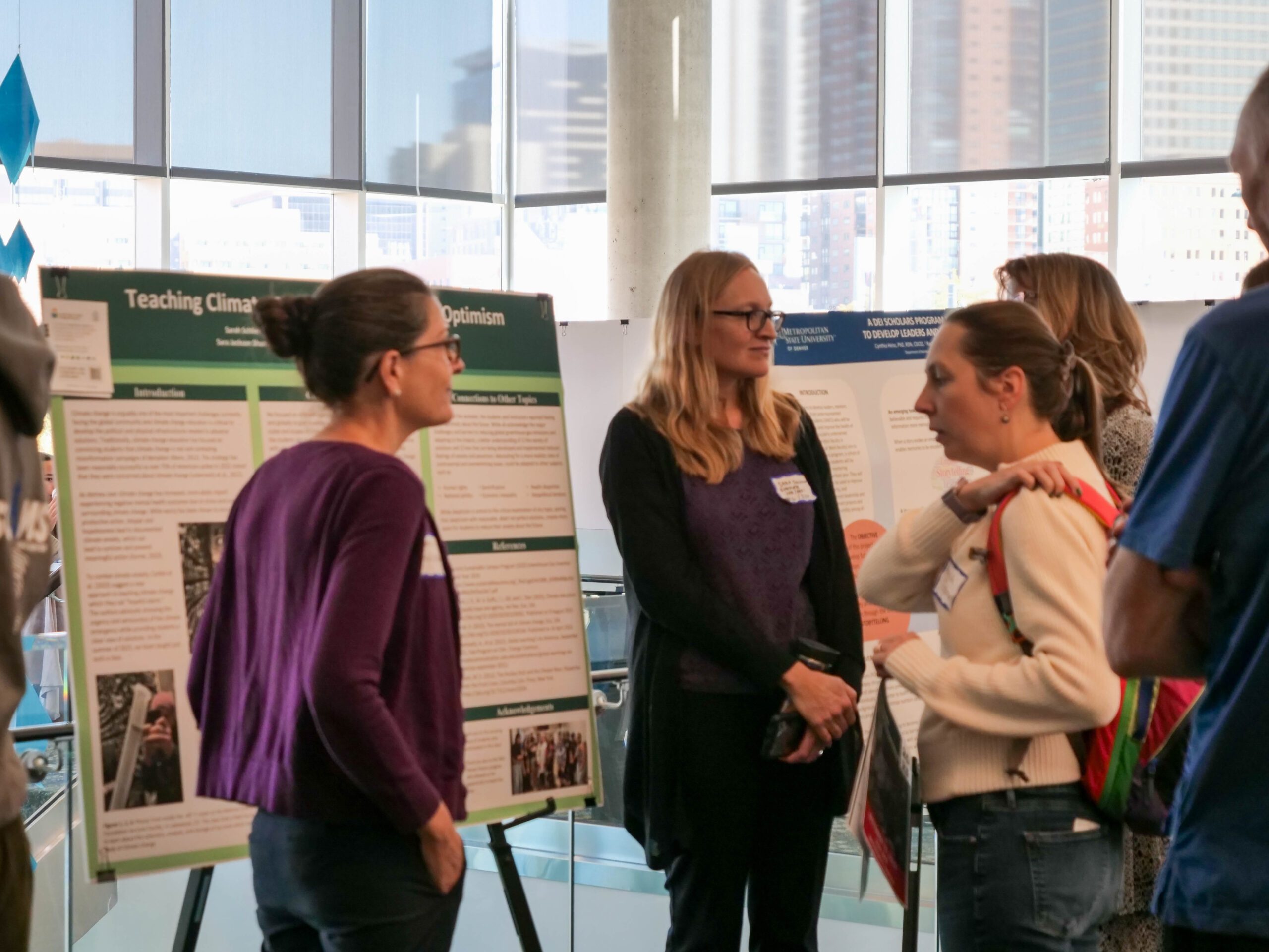 Faculty and staff discussing research projects at the SoTL poster session