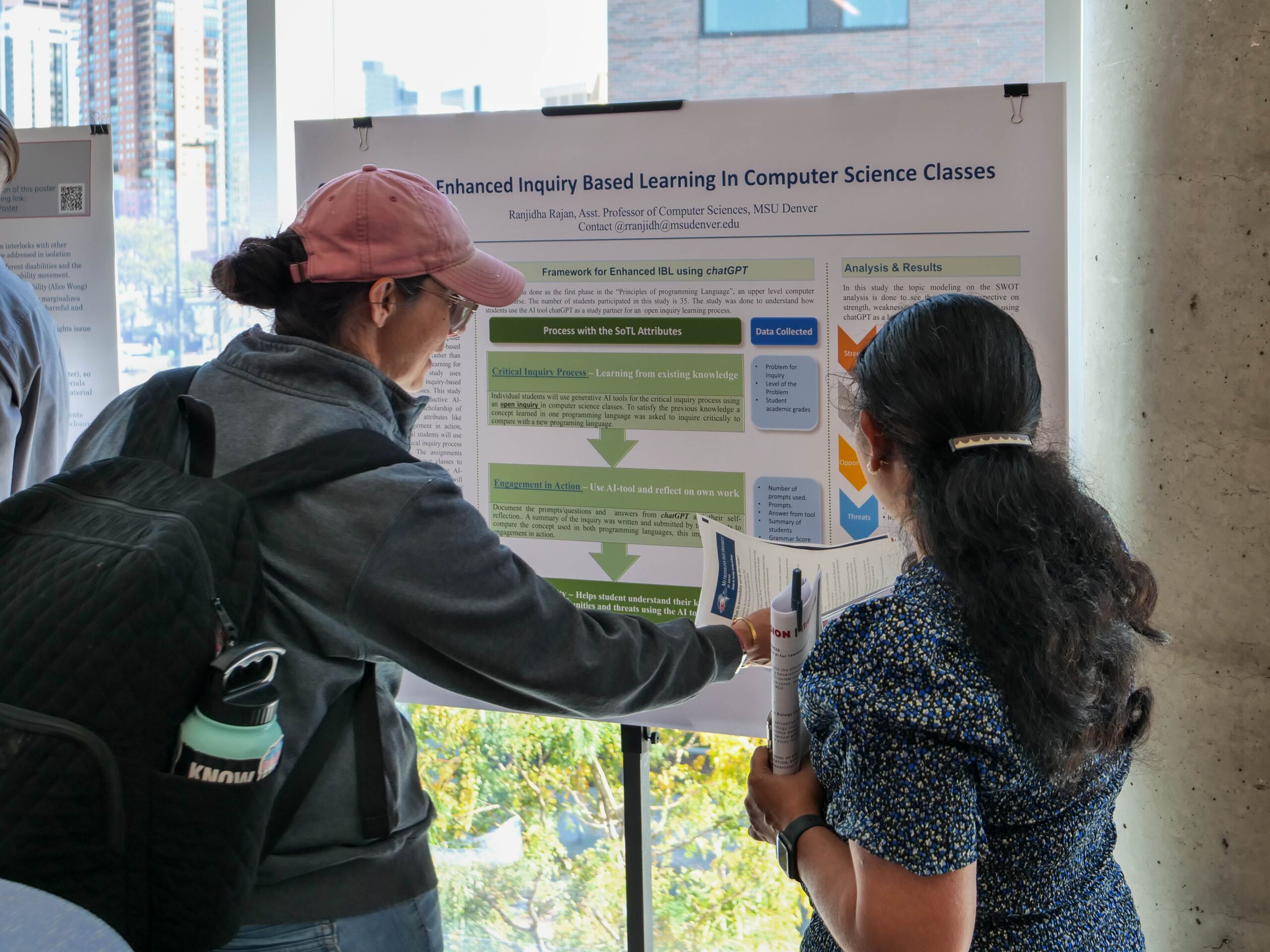 Faculty and staff discussing research projects at the SoTL poster session