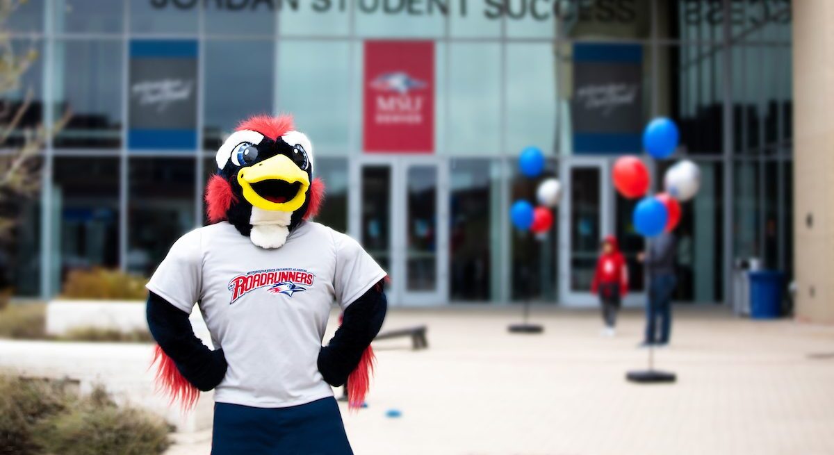 Rowdy stands confidently in front of the Jordan Student Success Building