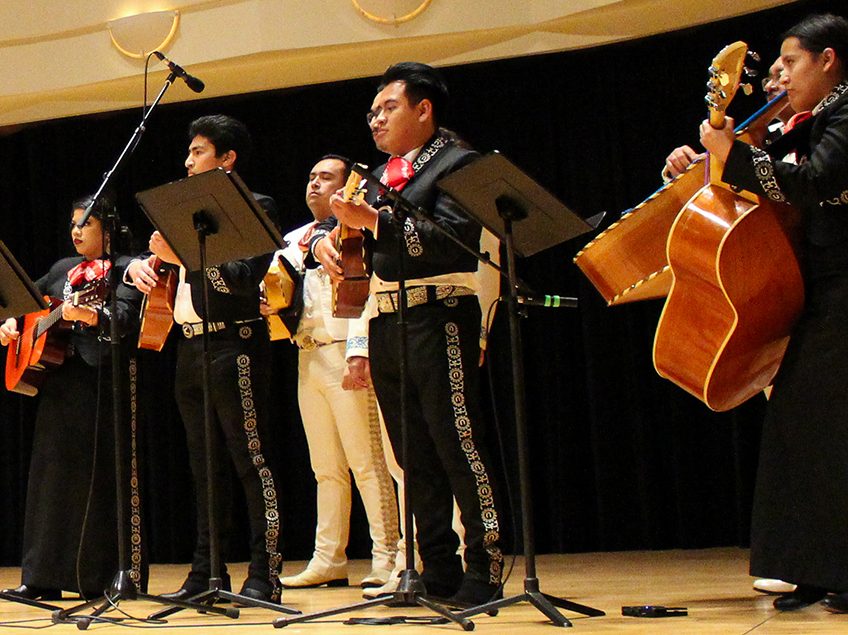 mariachi performers standing on a stage