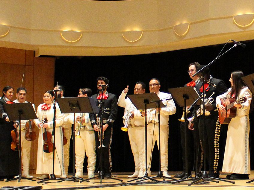 mariachi performers standing on a stage