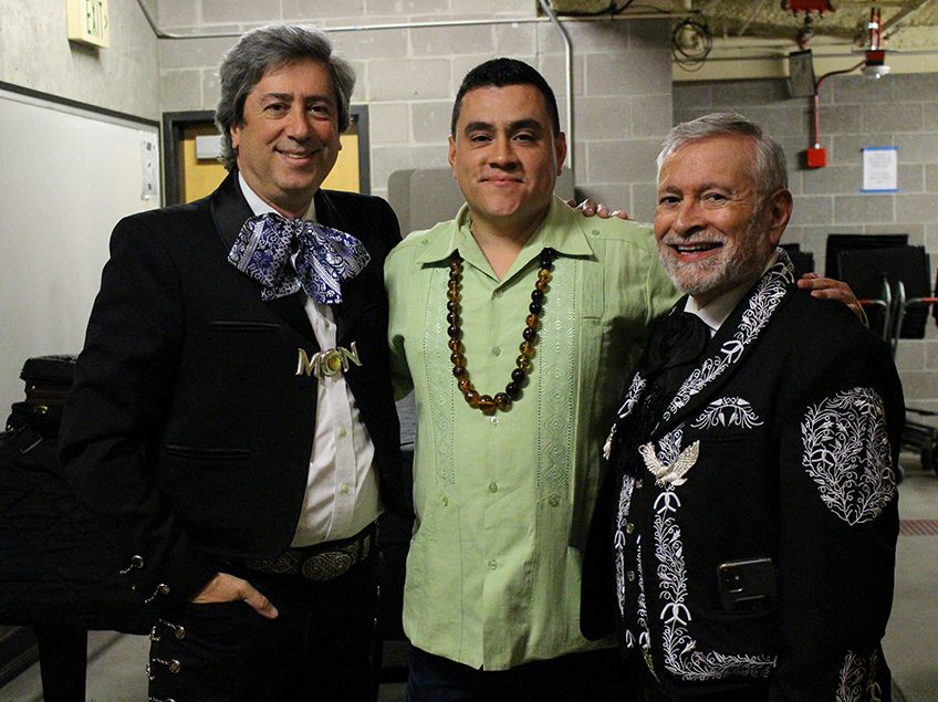 three instructors posting at a conference