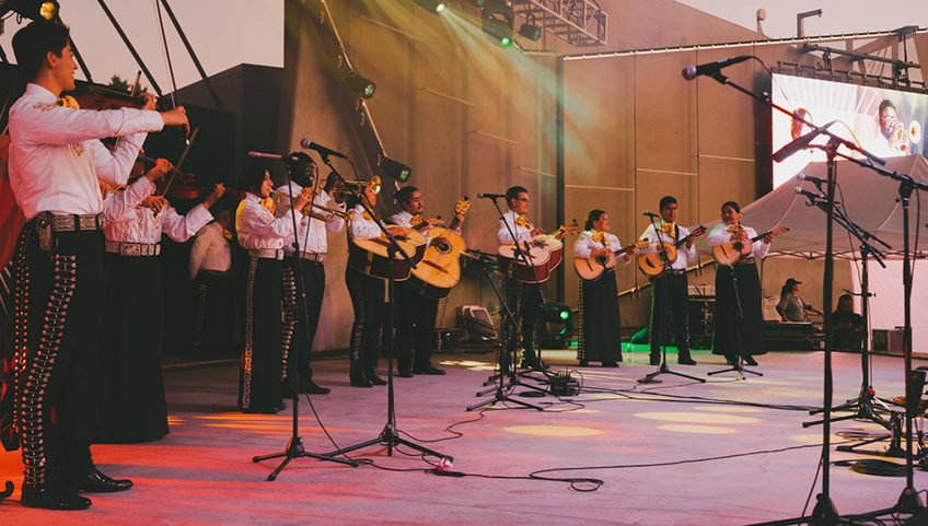 mariachi group onstage playing instruments