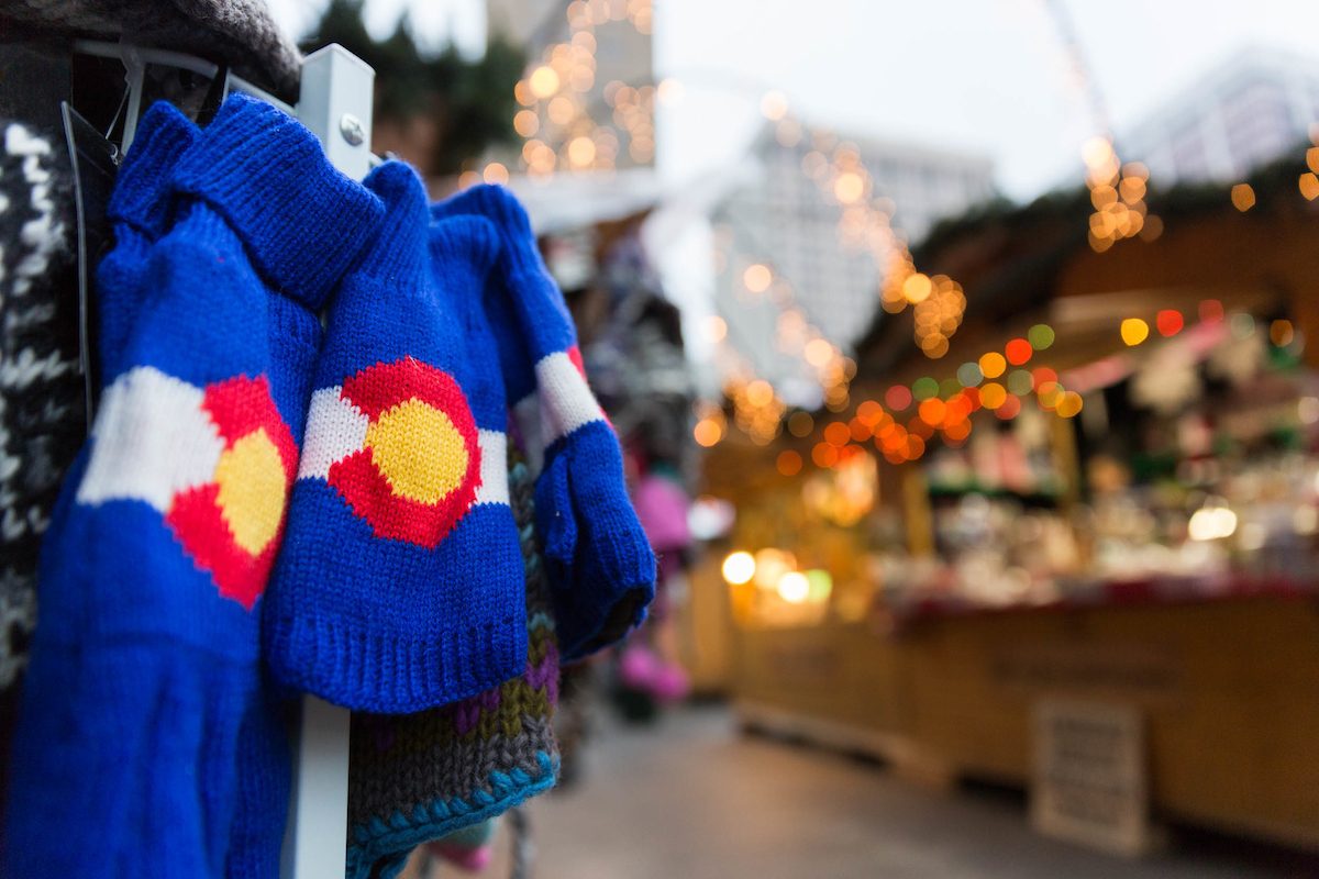 Winter wear with colorado logo in front of holiday lights downtown