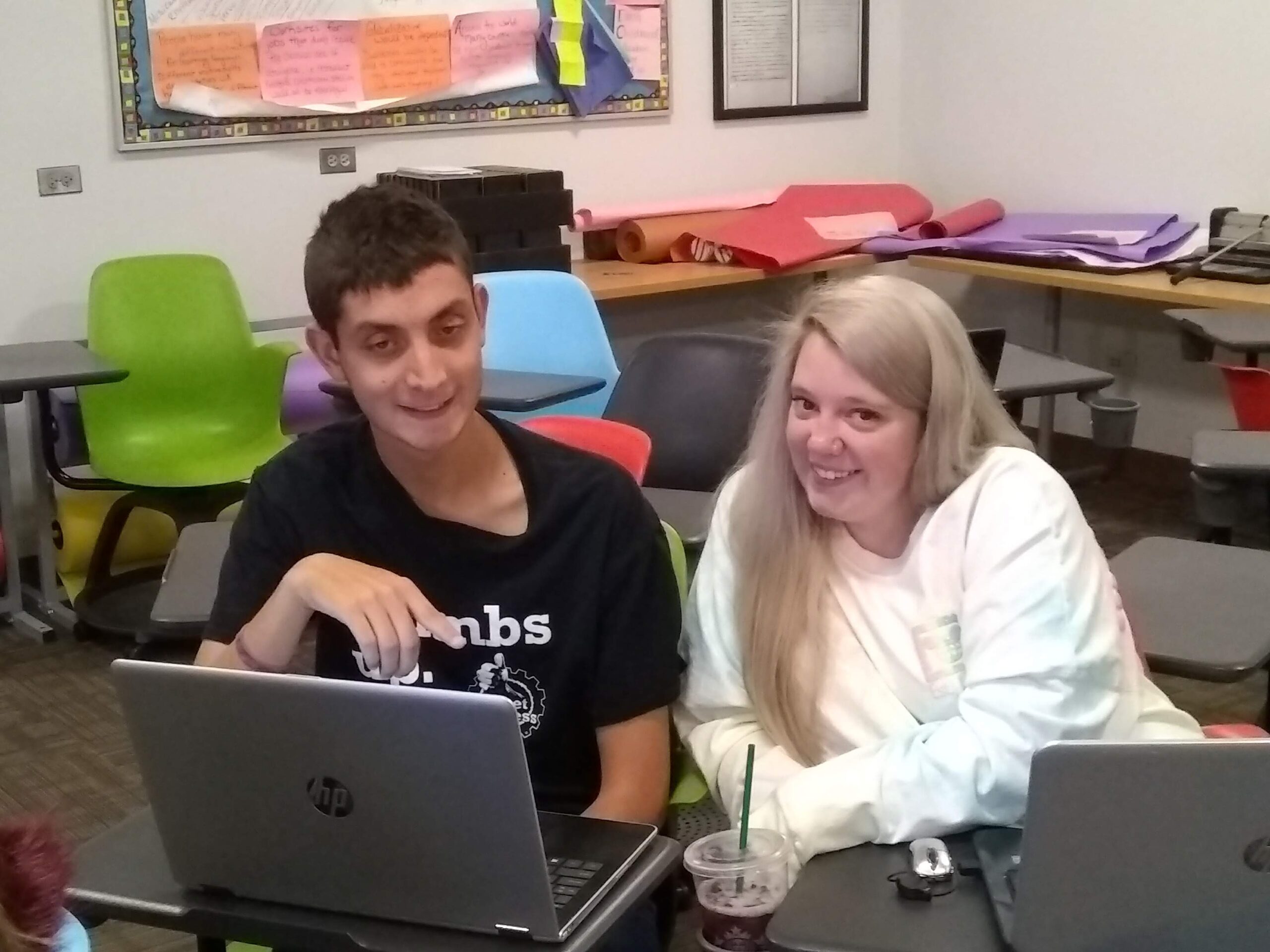 Decorative: Inclusive Higher Education Student works with an Academic Coach at a laptop
